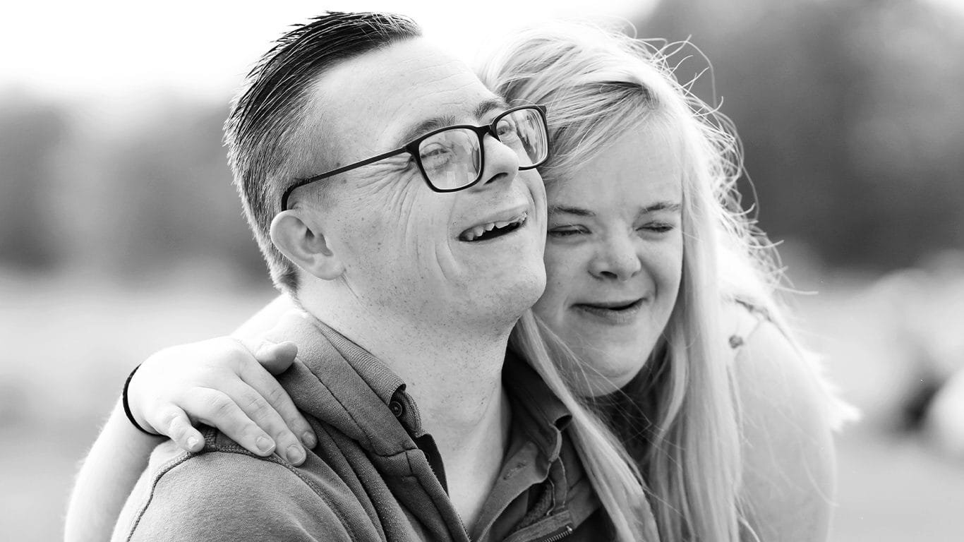 Support worker and young adult with learning disability sharing a warm moment at home